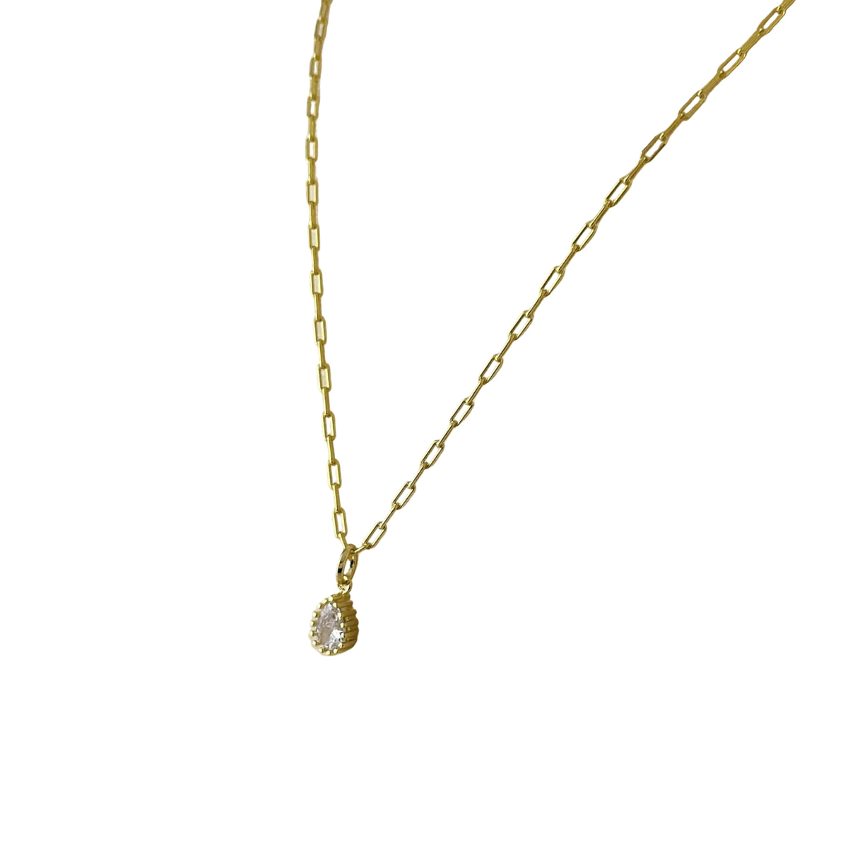 Close-up of pear CZ in scalloped vintage setting necklace