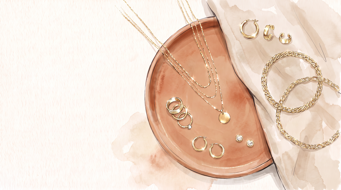 Illustration of 18K gold-filled necklaces, rings, bracelets and earrings arranged for jewelry layering