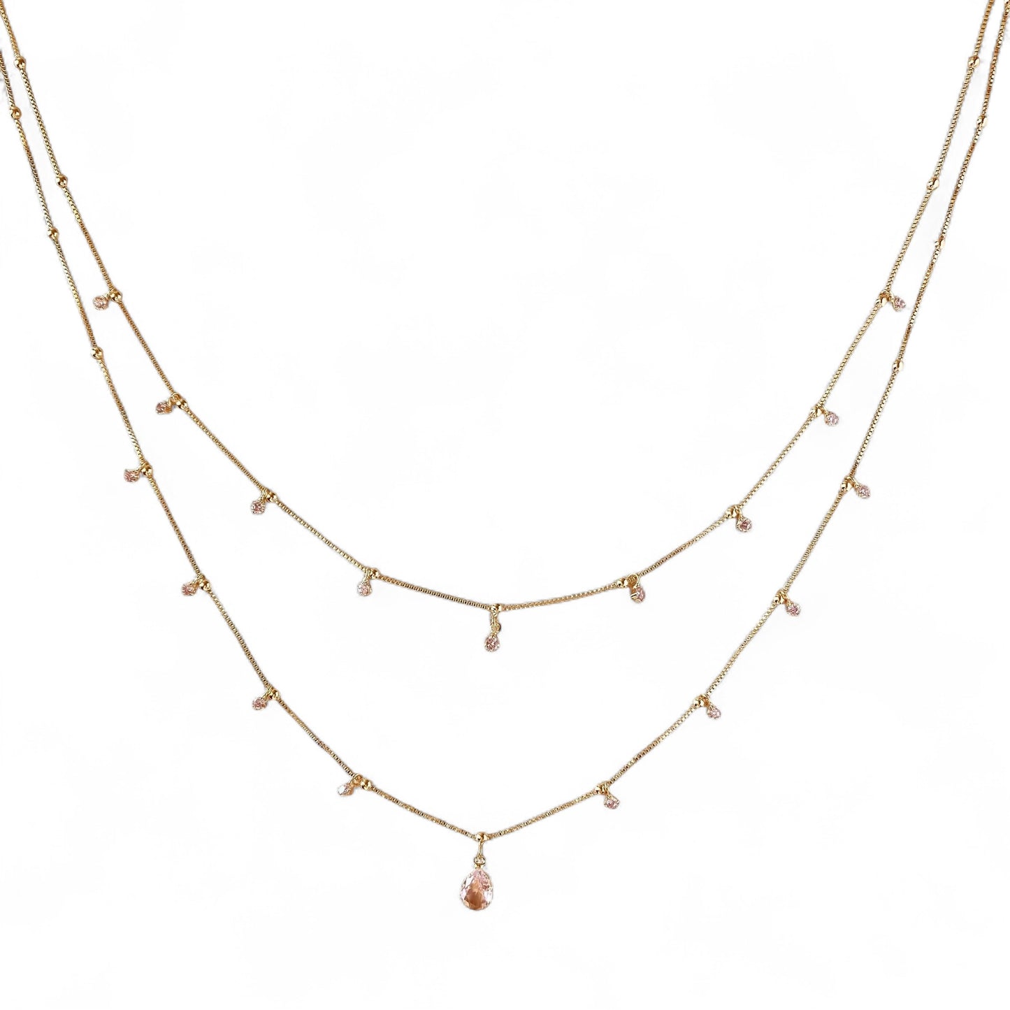 A delicate two-layer gold necklace with small clear bead accents