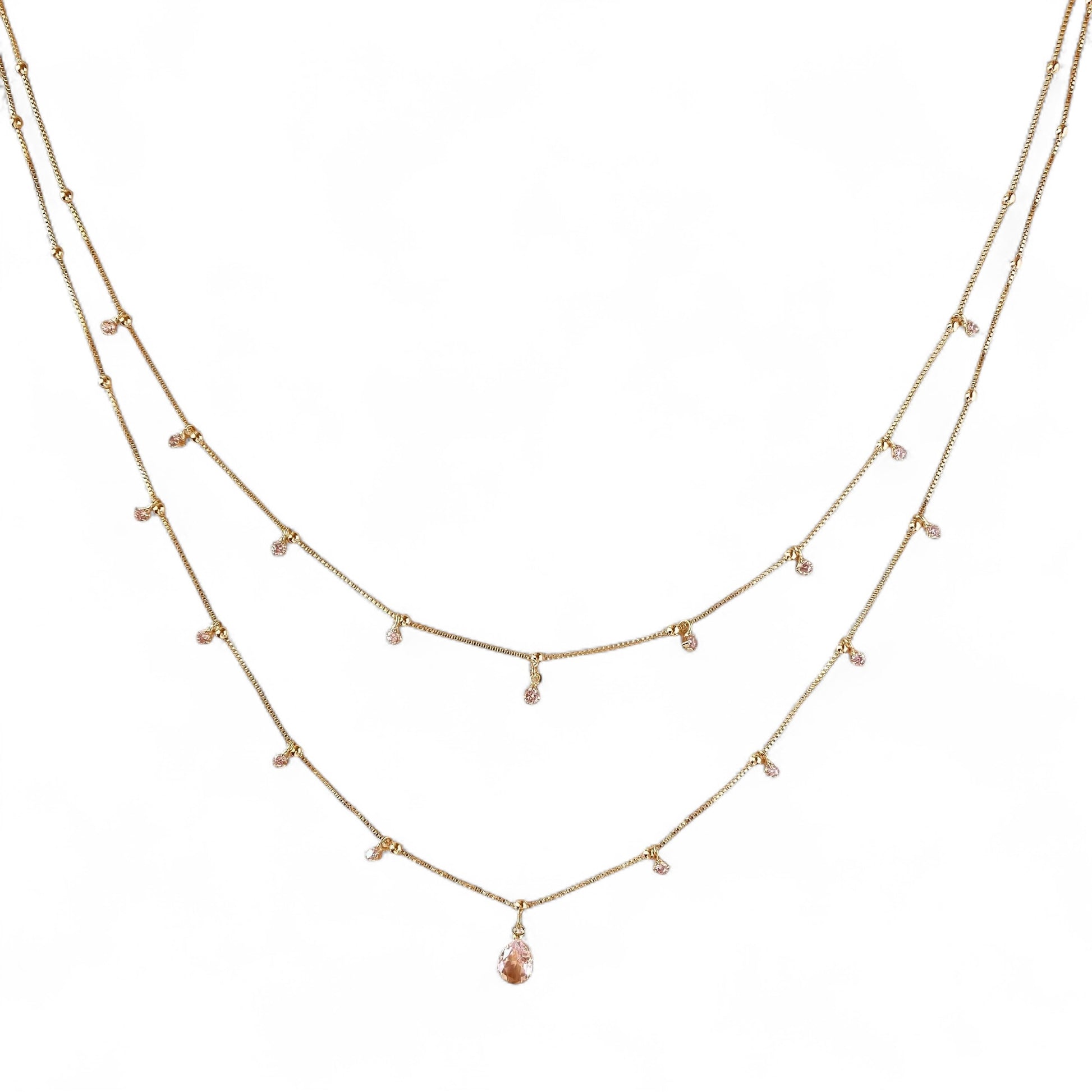 A delicate two-layer gold necklace with small clear bead accents
