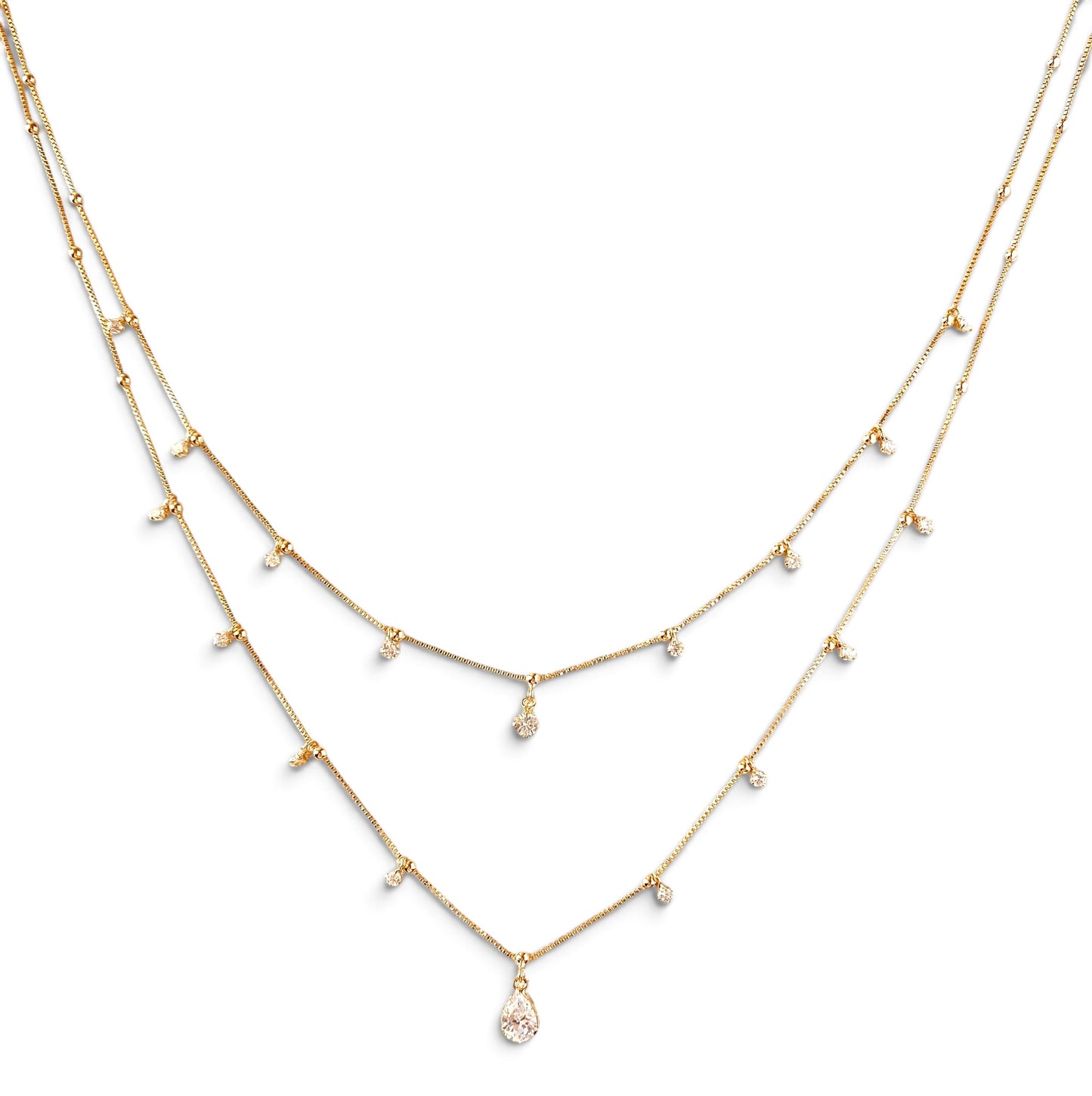 A gold-toned multi-layer necklace featuring delicate chains with small bead accents and a teardrop-shaped clear gemstone pendant at the center, shown against a plain white background.