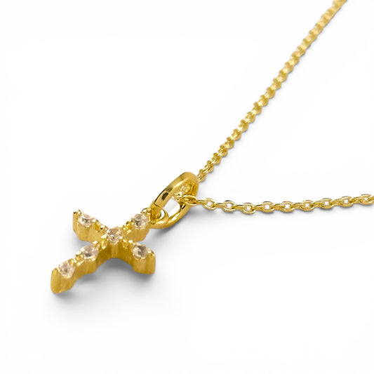 Close-up of cubic zirconia stones on cross pendant