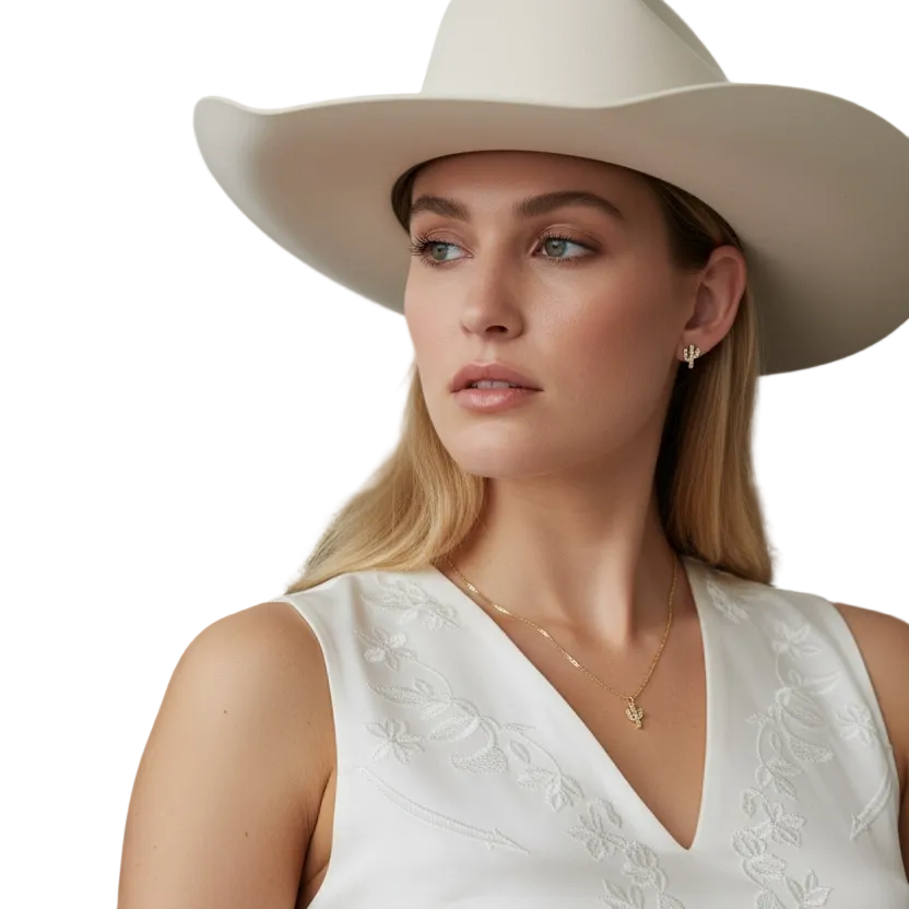 Woman wearing a white dress and beige hat sitting on a brown leather couch.