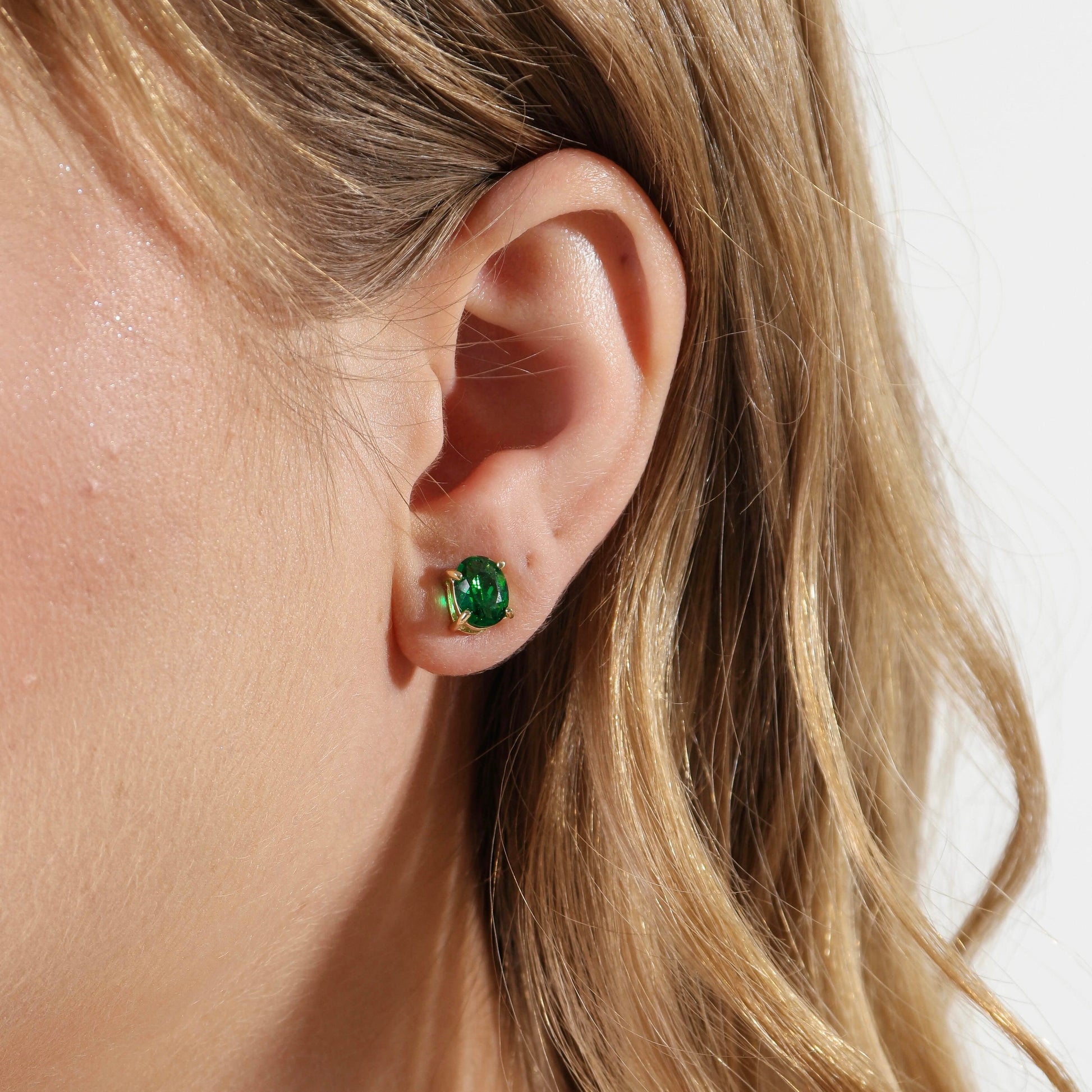 Oval Emerald CZ Stud Earrings on model
