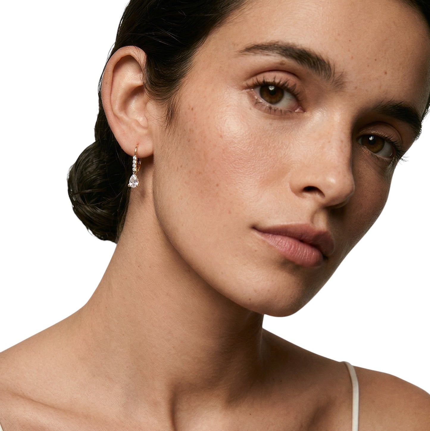 Teardrop drop earrings styled on ear showing sparkle
