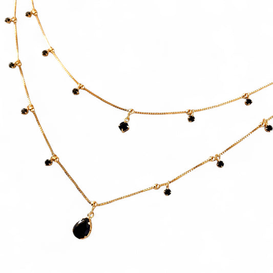 Two layered gold-tone chain necklaces with small black bead accents 
