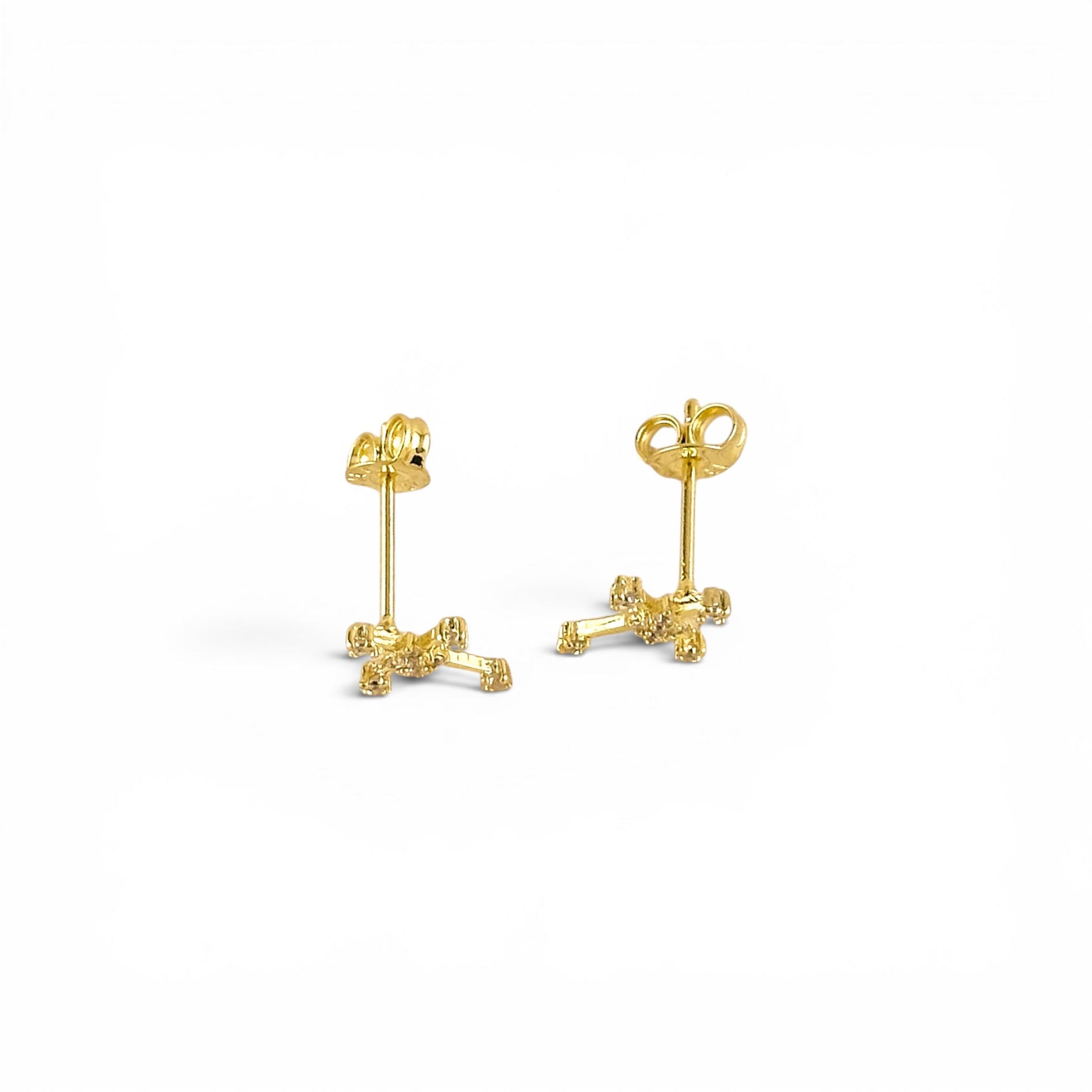 Close-up of cubic zirconia stones on cross stud earrings