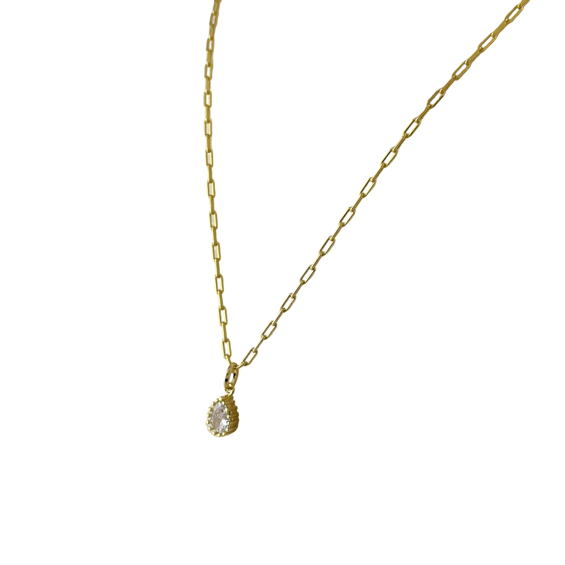 Close-up of pear CZ in scalloped vintage setting necklace 