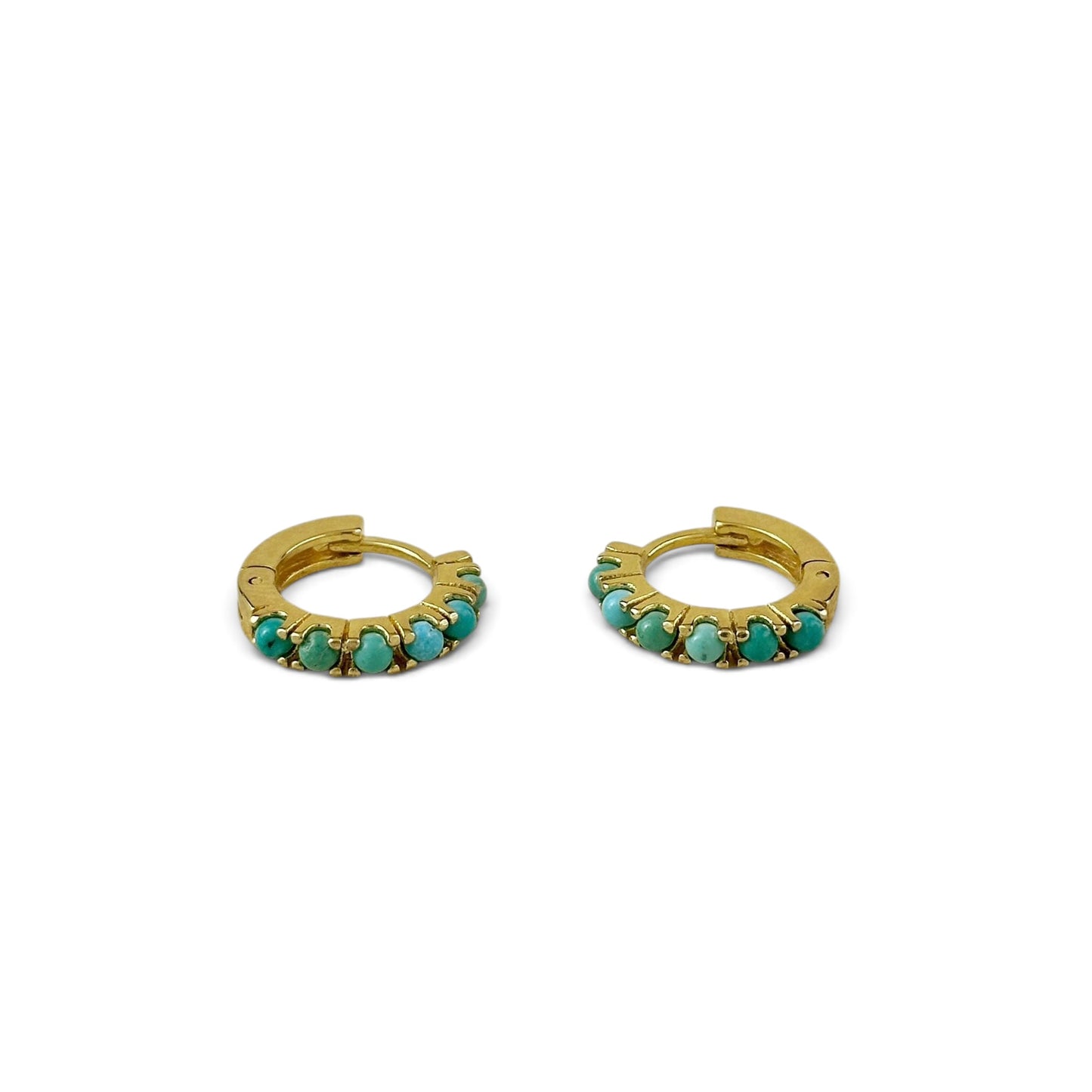 A pair of gold huggie hoop earrings embellished with small round turquoise-blue stones, displayed on a clean white background.