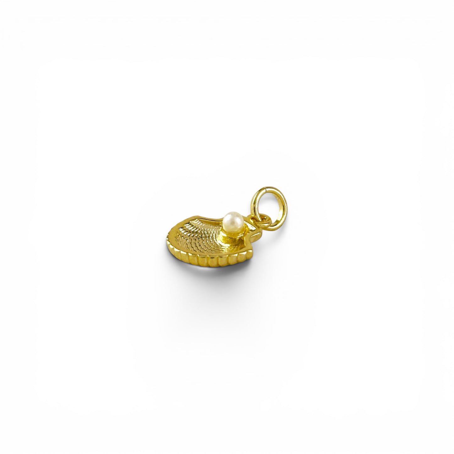 Close-up of pearl center on scallop shell charm