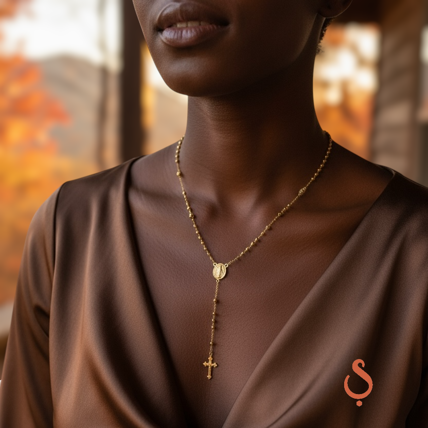 Woman wearing 18K gold filled rosary necklace with cross pendant by Skillus